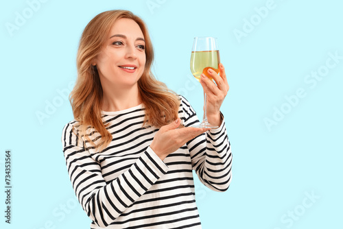 Mature woman with glass of ...