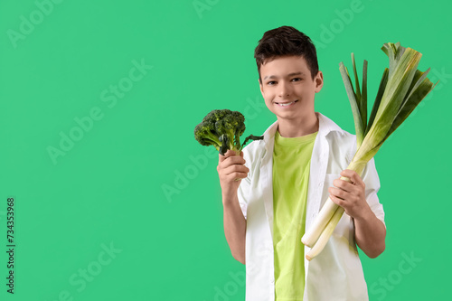 Smiling young boy holding f...
