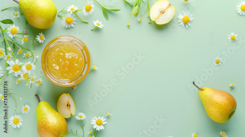 jar of pear jam with chamomile, spring concept on pastel green background