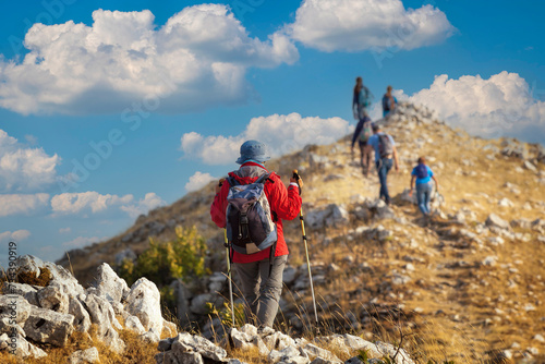 A group of hikers reaches the top of a mountain