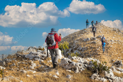A group of hikers reaches the top of a mountain