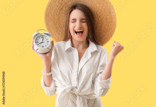 Young woman with alarm cloc...