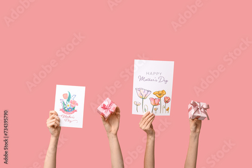 Women with gifts and drawings on pink background. Mother's Day celebration