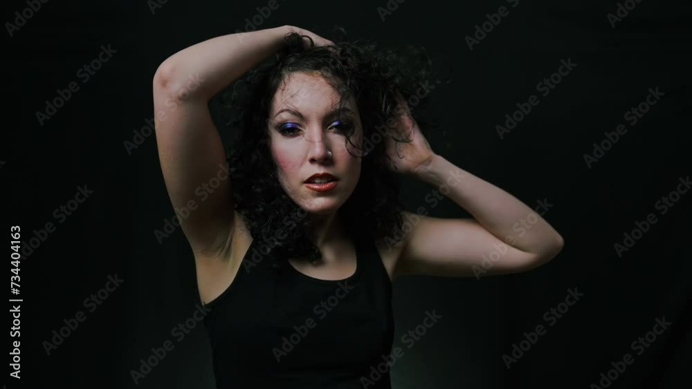 The Mysterious Gaze: A Curly-Haired Woman Against Black The Mysterious Gaze: A Curly-Haired Woman Against Black