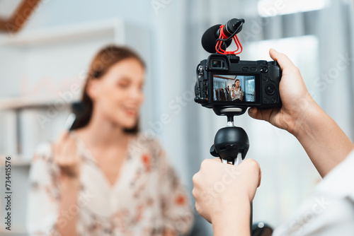 Woman influencer shoot live streaming vlog video review makeup utmost social media or blog. Happy young girl with cosmetics studio lighting for marketing recording session broadcasting online.