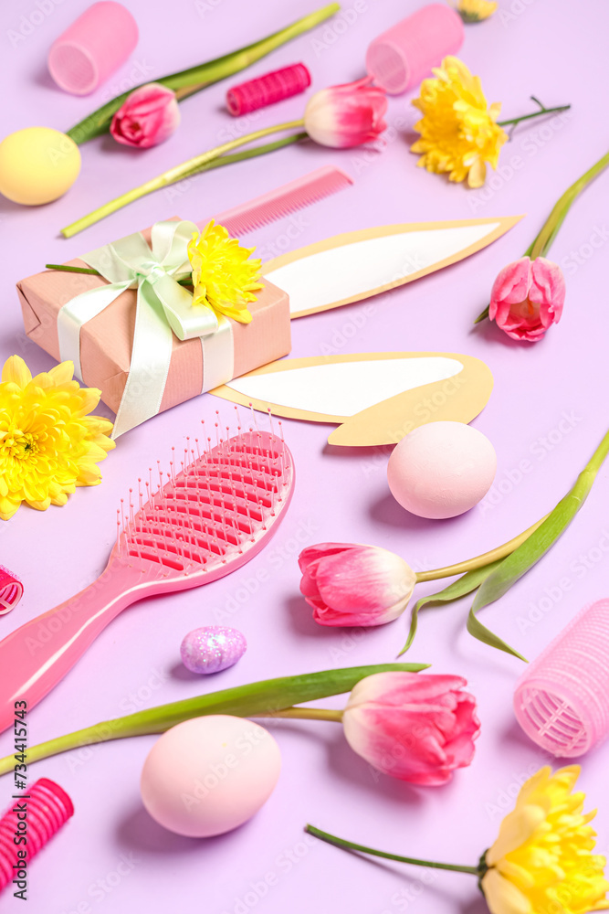 Composition with hairdresser's supplies, spring flowers and Easter eggs on color background