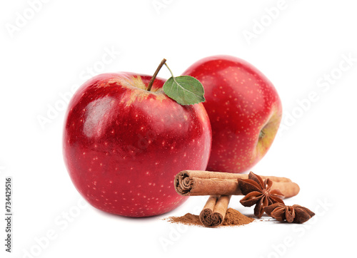 Aromatic cinnamon sticks, anise stars and red apples isolated on white