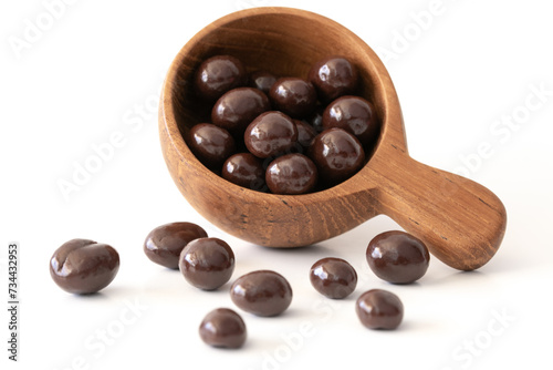 Chocolate Covered Coffee Beans Spilled from a Wood Scoop
