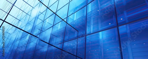 Low angle transparent blue glass wall office building