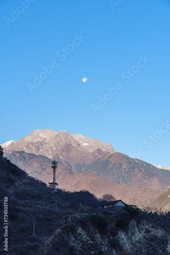 The Mountains and the Moon at Sunrise