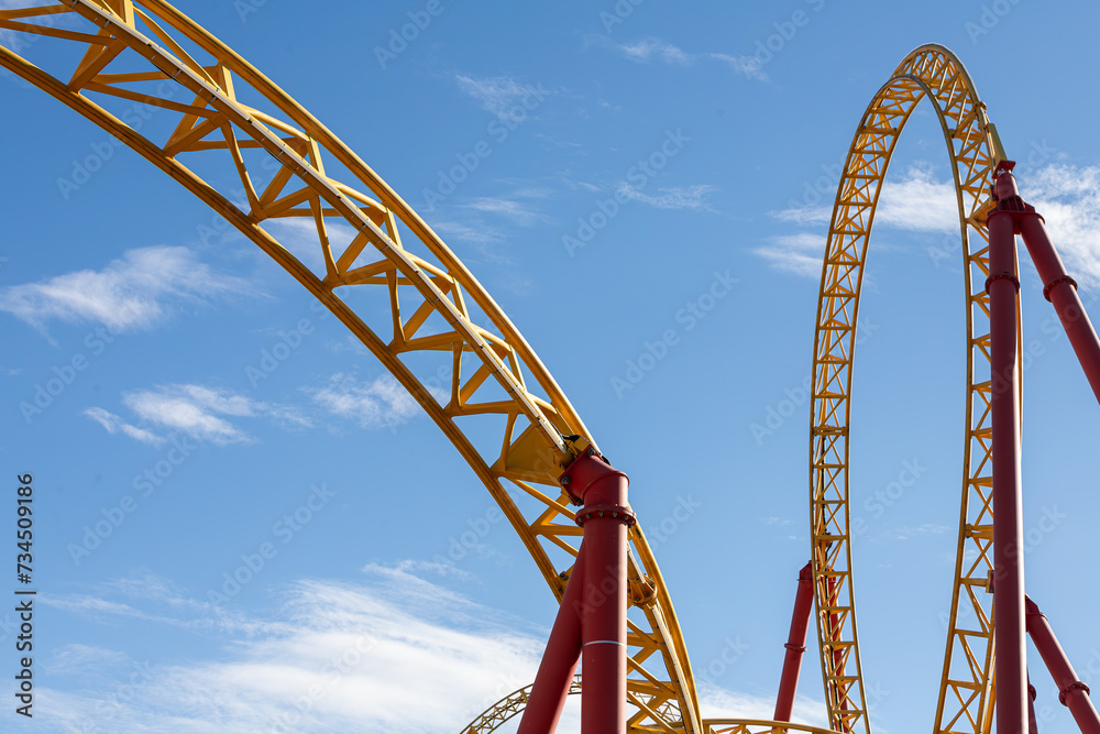 Roller coaster with twists, turns, cave, loops in amusement park Roller coaster with twists, turns, cave, loops in amusement park
