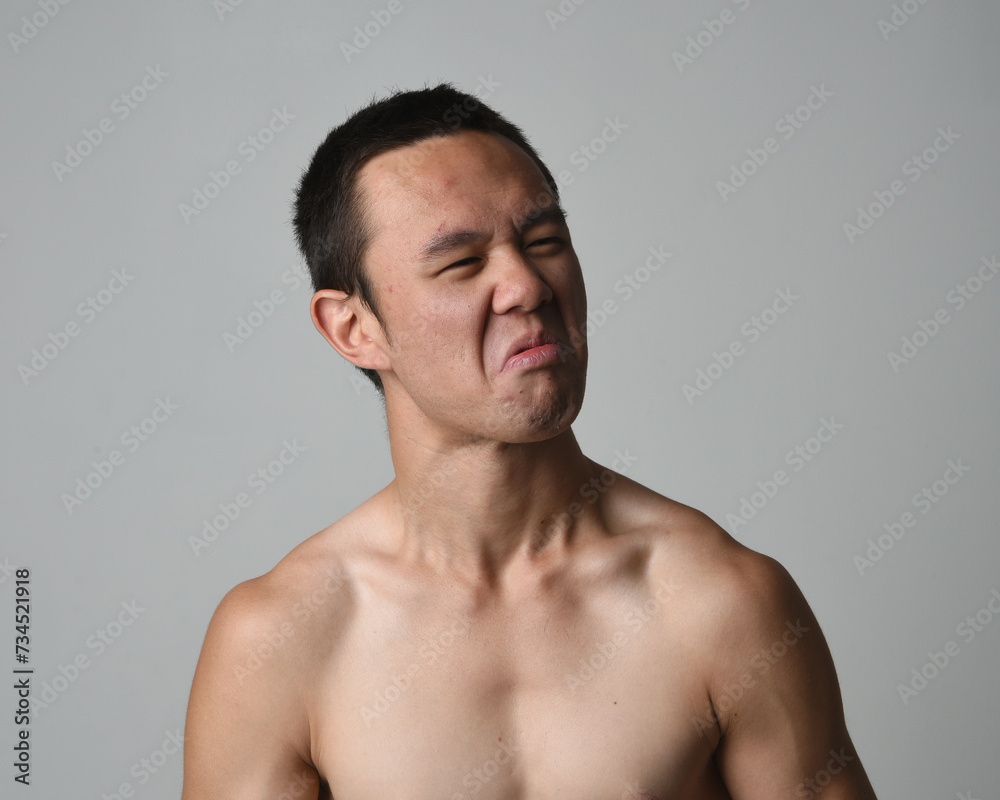 Close up portrait of asian male model, expressive and exaggerated facial expressions and silly faces. Isolated on a white studio background Close up portrait of asian male model, expressive and exaggerated facial expressions and silly faces. Isolated on a white studio background