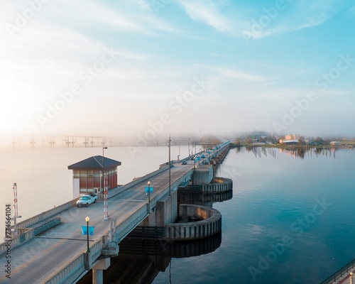 Drawbridge extending over the Trent River on a foggy summer morning  photo