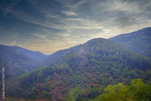 This captivating image showcases the dynamic and rich landscape of the Ardeche region. A delicate veil of mist wraps around the green clad hills under a dramatic sky, highlighting the natural beauty © Bjorn B