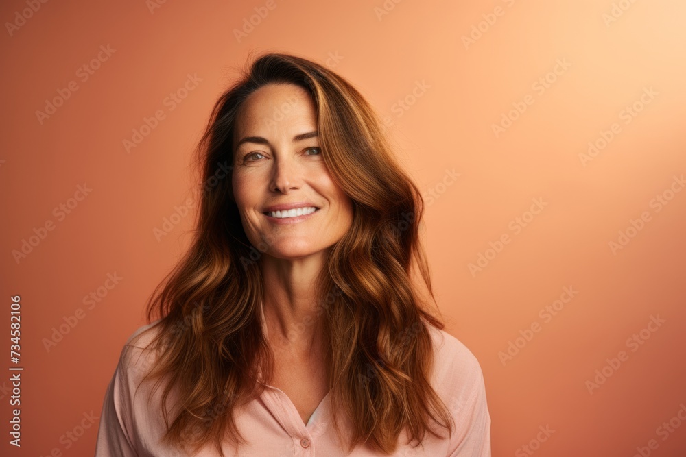 Portrait of a beautiful woman with long brown hair. Studio shot. Portrait of a beautiful woman with long brown hair. Studio shot.