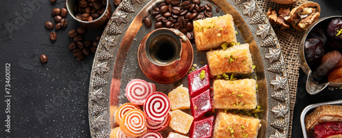 Traditional turkish coffee and turkish delight on dark background.