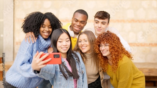 Chinese girl taking a selfie with diverse friends