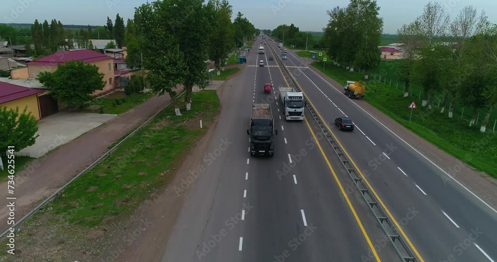 A drone flies in front of the cab of a truck driving on the highway. A drone flies in front of the cab of a truck driving on the highway.