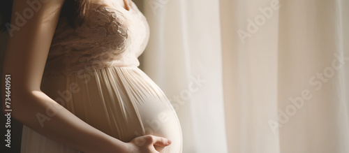 Expectant Mother in Elegant Dress Cradling Her Belly. Maternity Elegance and Anticipation Concept
