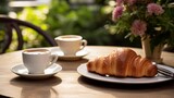 A french bistro table with croissants and coffee