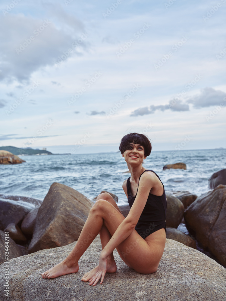 Pretty female model enjoying freedom and relaxation at the sunny beach by the serene ocean Pretty female model enjoying freedom and relaxation at the sunny beach by the serene ocean