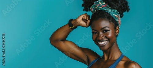 Attractive African American woman showcasing her muscular arms with a bicep flex.