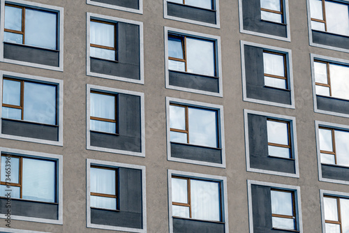 A fragment of the facade of a multi-storey residential building on a winter day