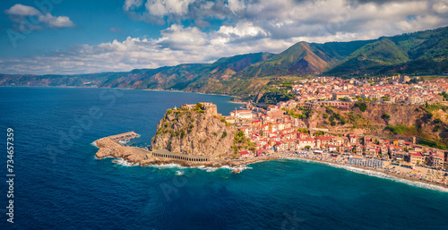 Fototapeta Naklejka Na Ścianę i Meble -  Aerial summer view from flying drone of Reggio Calabria, Italy, Europe. Astonishing morning cityscape of Scilla port. Spectacular seascape of Mediterranean sea. Traveling concept background.