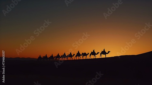 Silhouetted caravan of camels crossing desert at sunset.