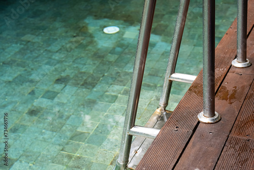 Outdoors swimming pool ladder. Summery vacations.