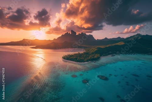 drone view, wide angle view of a mountain beach Island with clear blue ocean and vibrant cloudy sunset