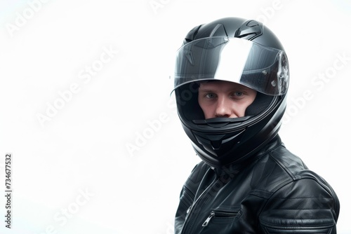 A biker shows off his sleek black helmet against a crisp white backdrop. © tonstock