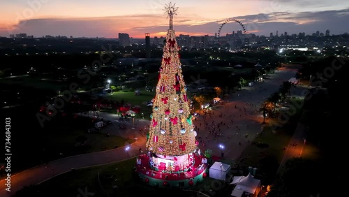 Christmas Tree At Candido Portinari Park Sao Paulo Brazil. Holydays New Year. Sunset Sky Background Downtown Cityscape. Sunset Outside Downtown Illumination Panoramic. photo