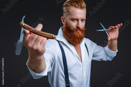 Hairdressing skills of man. Retro hairdresser holding razor and scissors isolated on black. Haircut at hairdresser man. Barber making hairstyle. Advertising for barbershop. Selective focus