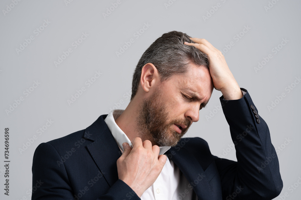 Business problems. Head pain migraine. Business man in suit with migraine. Business man got migraine touches her head because of pain. exhaustion. Tired exhausted man suffering from headache Business problems. Head pain migraine. Business man in suit with migraine. Business man got migraine touches her head because of pain. exhaustion. Tired exhausted man suffering from headache