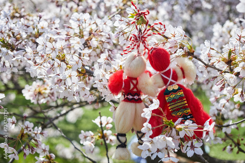 Bulgarian traditional spring decor Martenitsa on the cherry blossom tree. Baba Marta holiday. photo