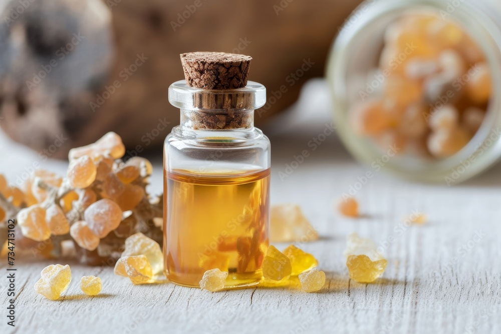 Frankincense essential oil and resin on white table Frankincense essential oil and resin on white table