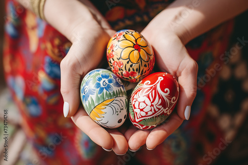 Hands holding painted easter eggs.