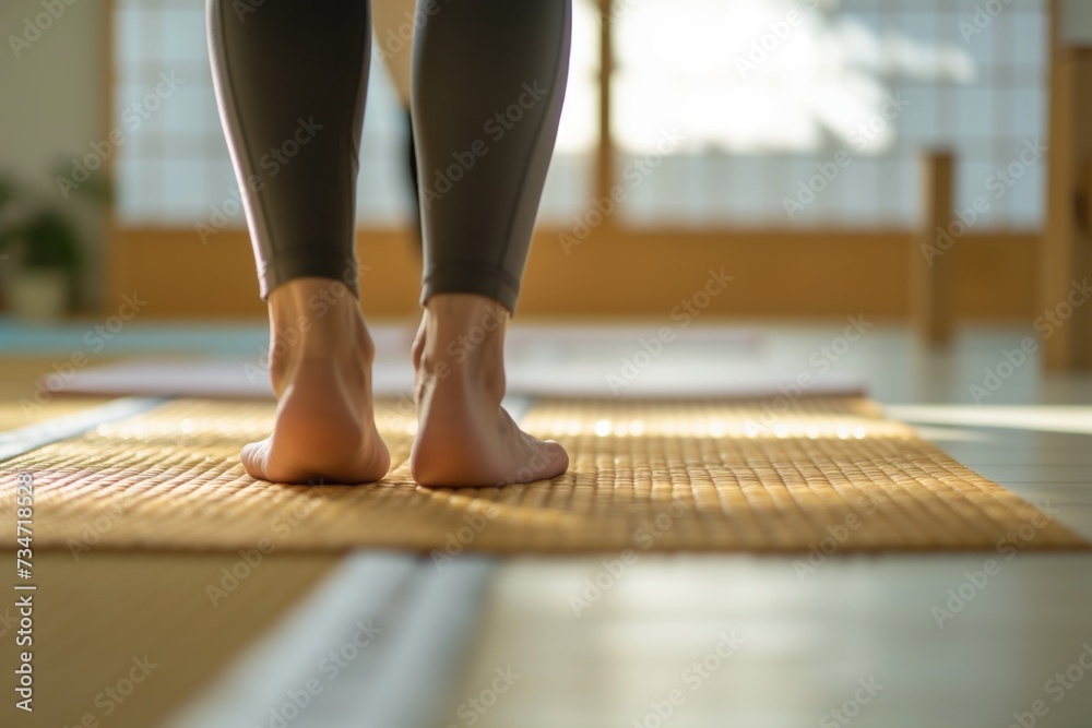 person practicing yoga on a tatami mat in a bright gym - obrazy, fototapety, plakaty 