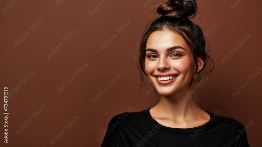 Woman with bun in her hair smiles. This picture can be used to portray happiness and positivity Woman with bun in her hair smiles. This picture can be used to portray happiness and positivity