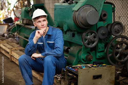 technician or worker with lathe machine and thinking about work in the factory
