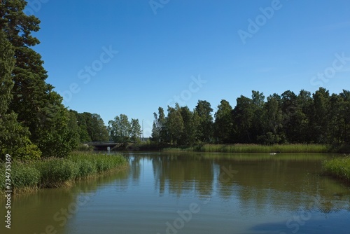 Urban landscape with sea and bridge in clear summer weather, Kuusisaari, Helsinki, Finland.