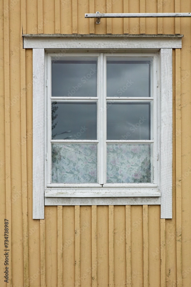 White framed window on yellow painted wooden wall. White framed window on yellow painted wooden wall.