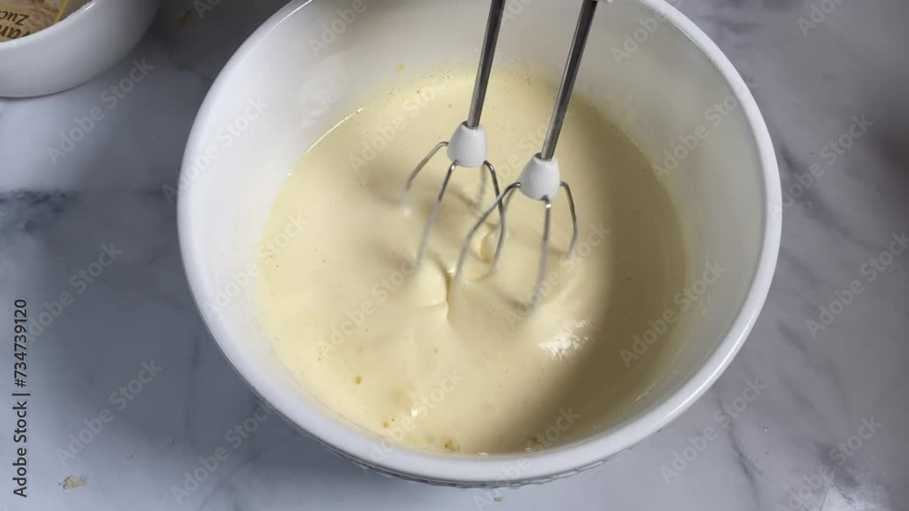 Frothy beaten eggs with a hand mixer in a bowl Frothy beaten eggs with a hand mixer in a bowl