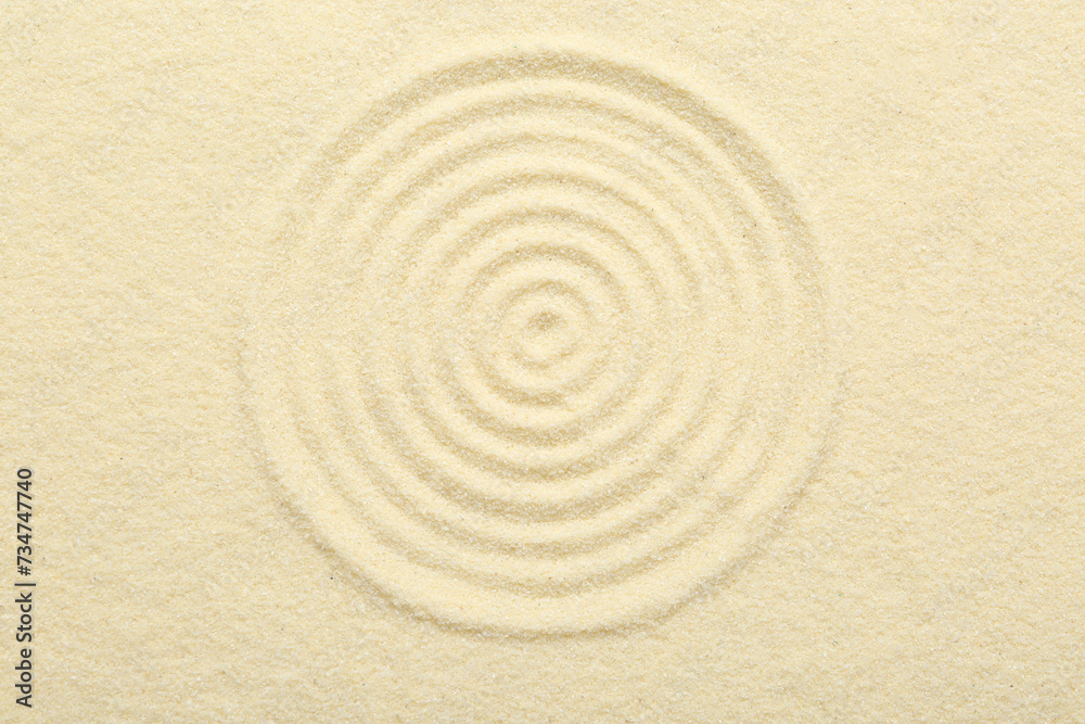 Zen rock garden. Circle pattern on beige sand, top view Zen rock garden. Circle pattern on beige sand, top view