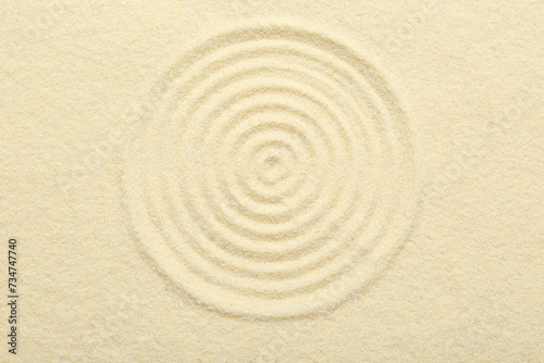 Zen rock garden. Circle pattern on beige sand, top view