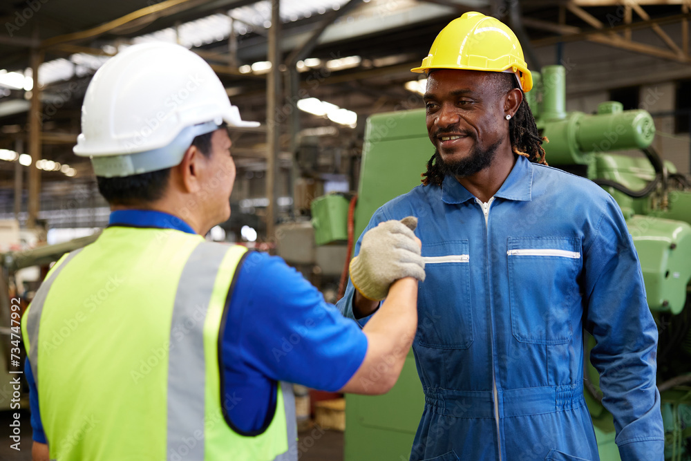 technician or engineer shaking hands with coworker before starting work in the factory technician or engineer shaking hands with coworker before starting work in the factory