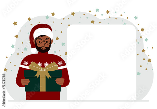A man in a red sweater is holding a large gift box with a bow. New Year or Christmas.