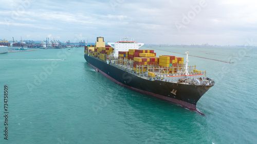 side view Cargo Container ship with contrail in the ocean ship carrying container and running for import export concept technology freight shipping by ship