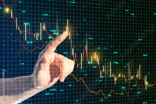 Close up of businessman hand pointing at glowing and growing business chart on blurry blue grid background. Financial growth, trade and stock concept. © Who is Danny